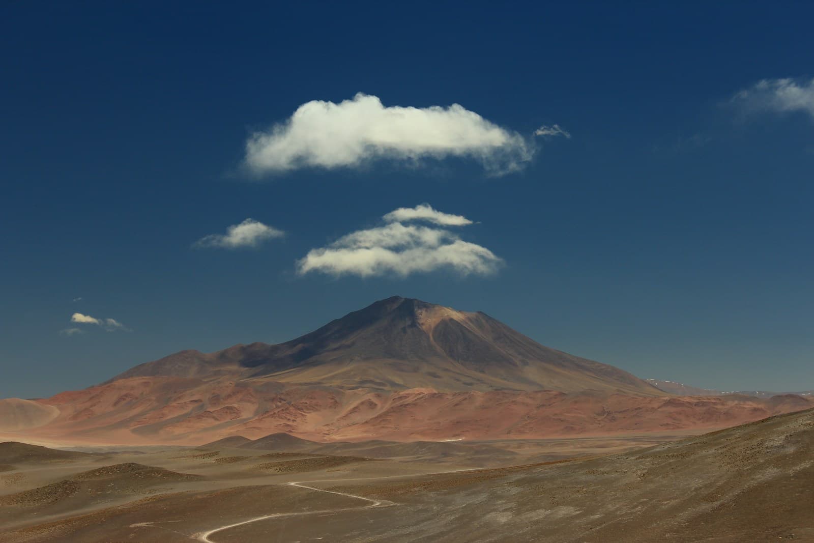 Valle verde y cordillera de los Andes bajo un cielo nublado